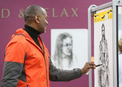Man drawing with marker on poster